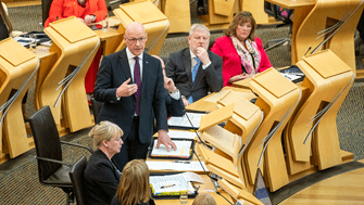 First Minister John Swinney speaking during First Minister's Questions on 16 May 2024